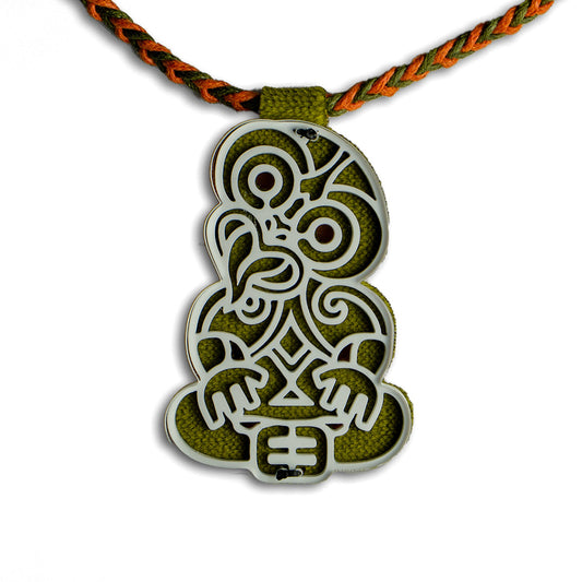 Decorative pendant with intricate patterns on a white background